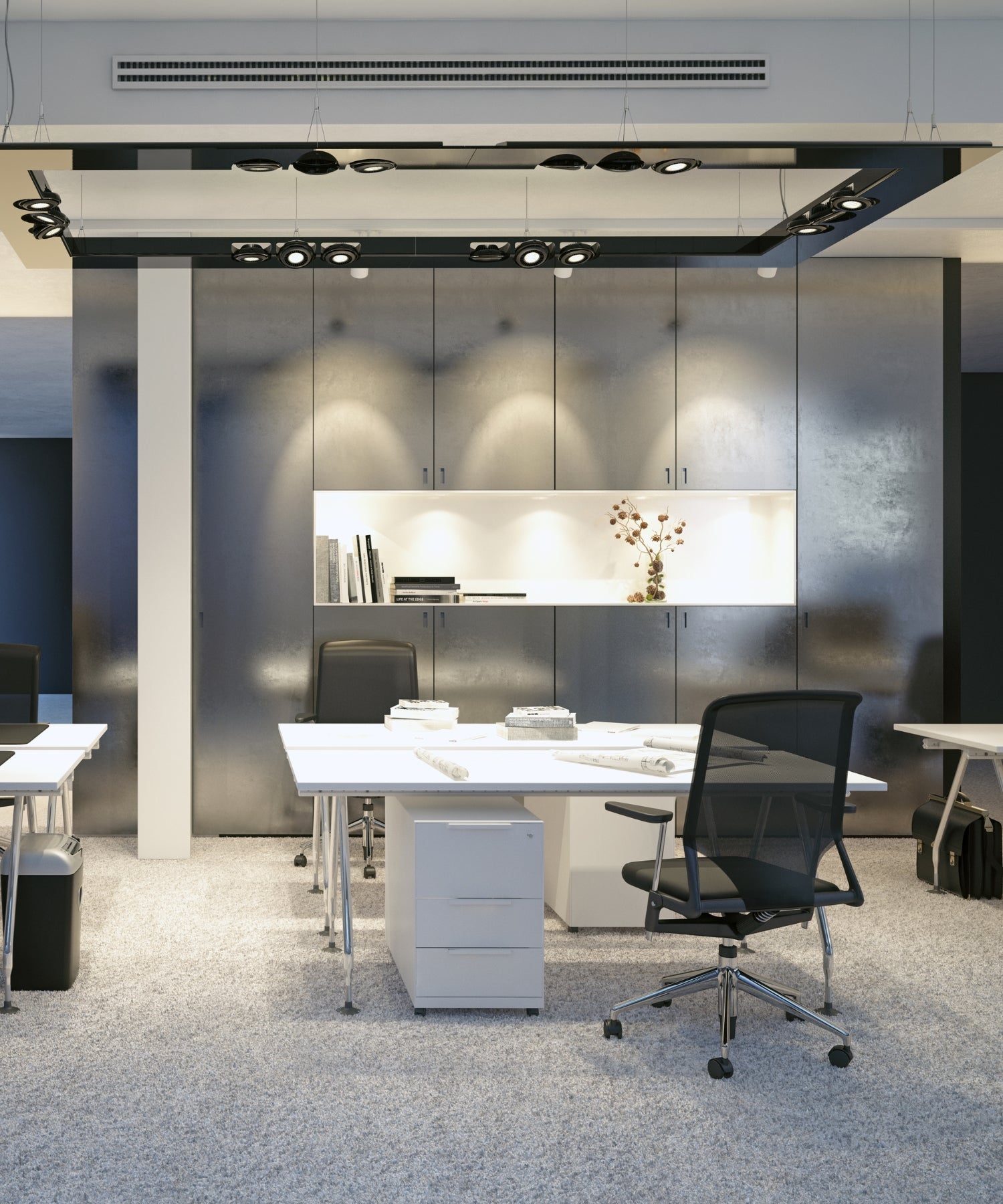 Modern office lighting in a space with desks, chairs and cabinets.