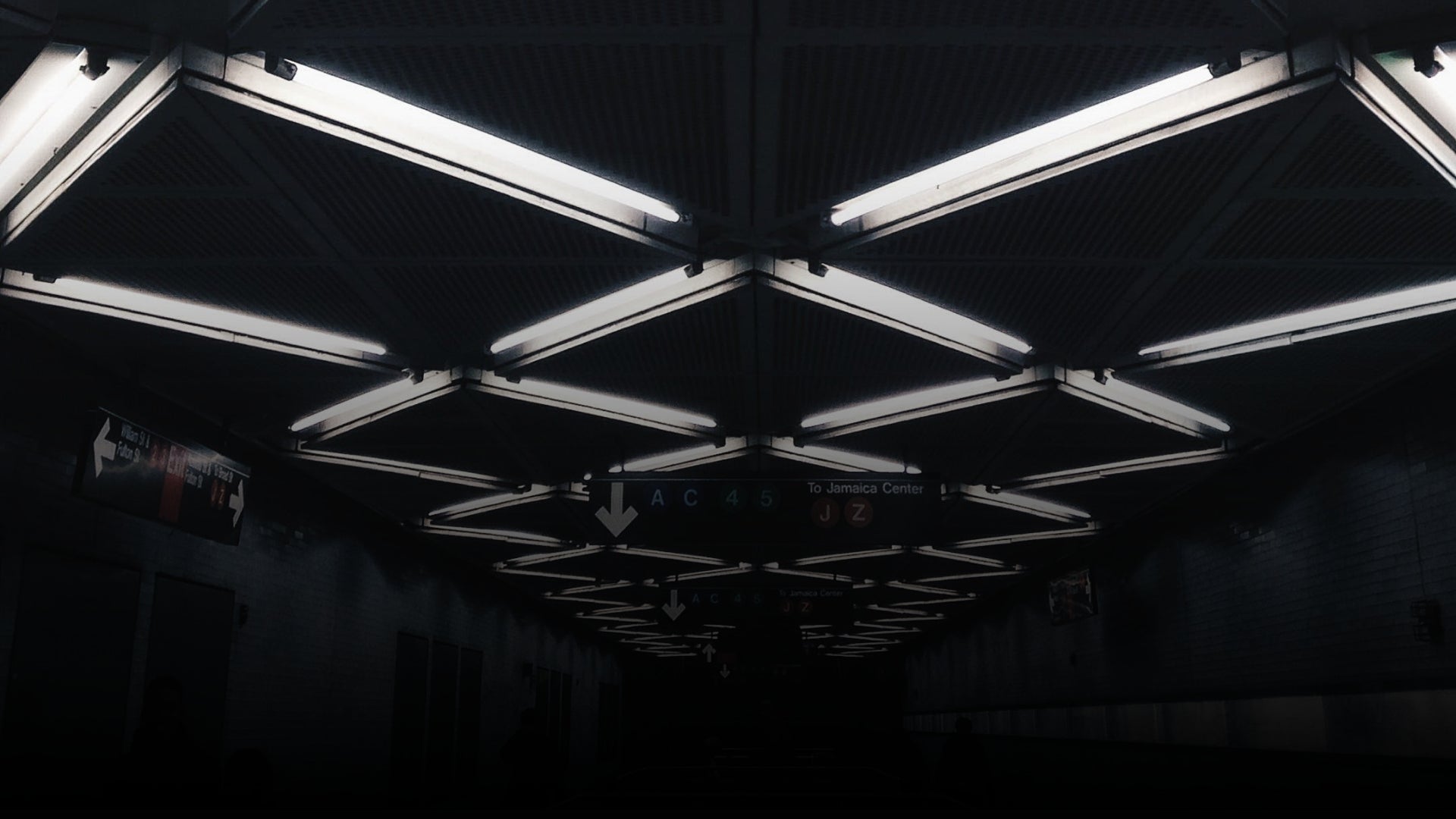 Ceiling with multiple fluorescent lights in a dark setting